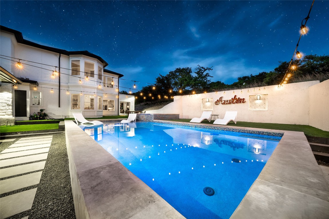 a view of a patio with dining table and chairs with a swimming pool