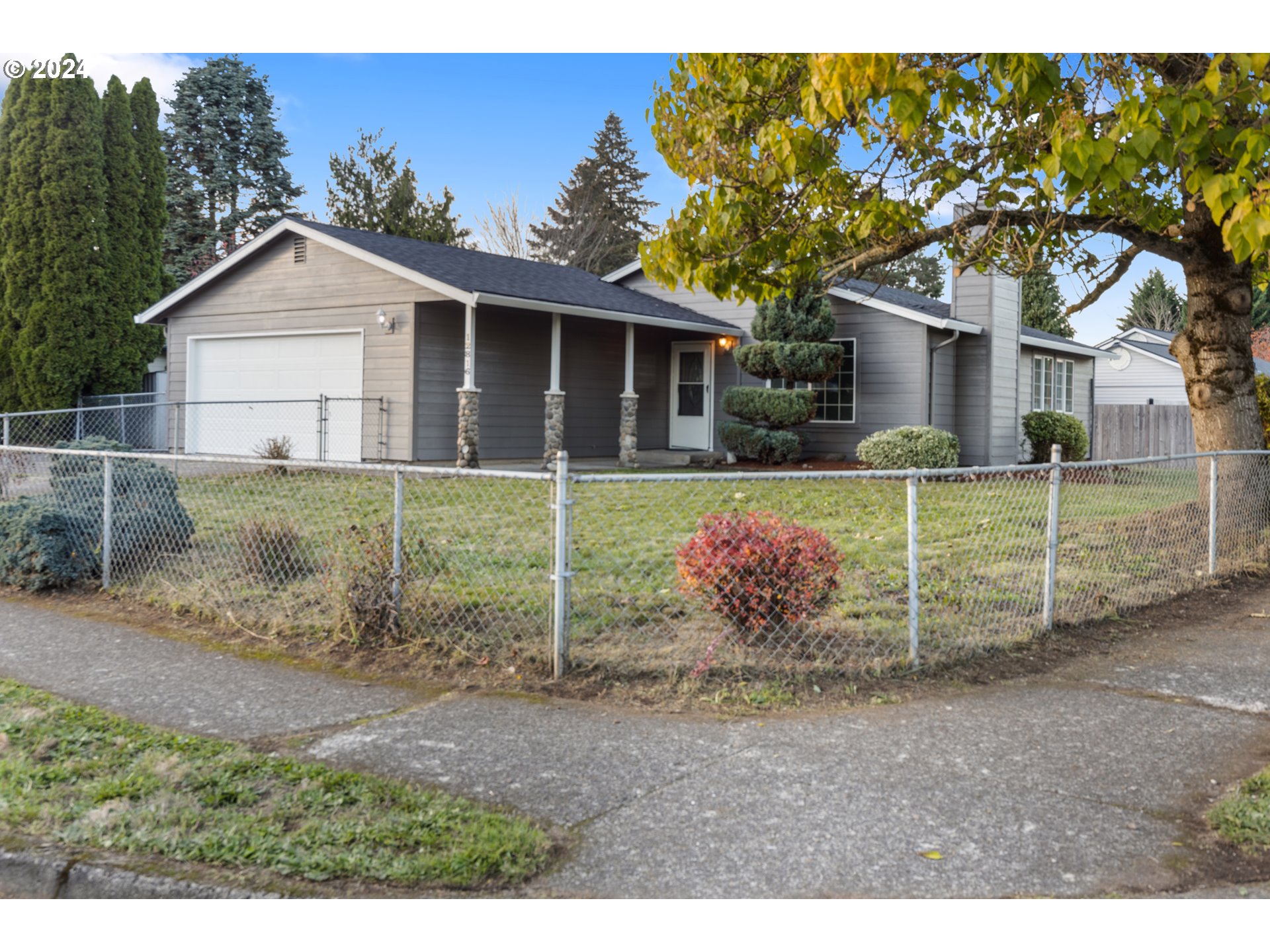 a view of a house with a yard and a garden