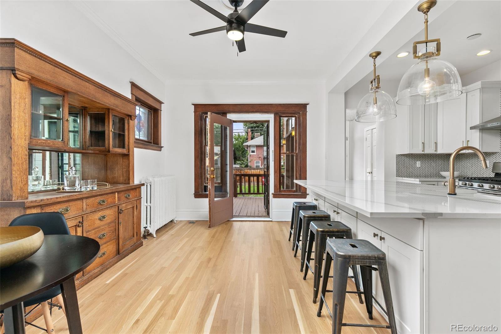 a view of a livingroom with furniture hardwood floor and a large window