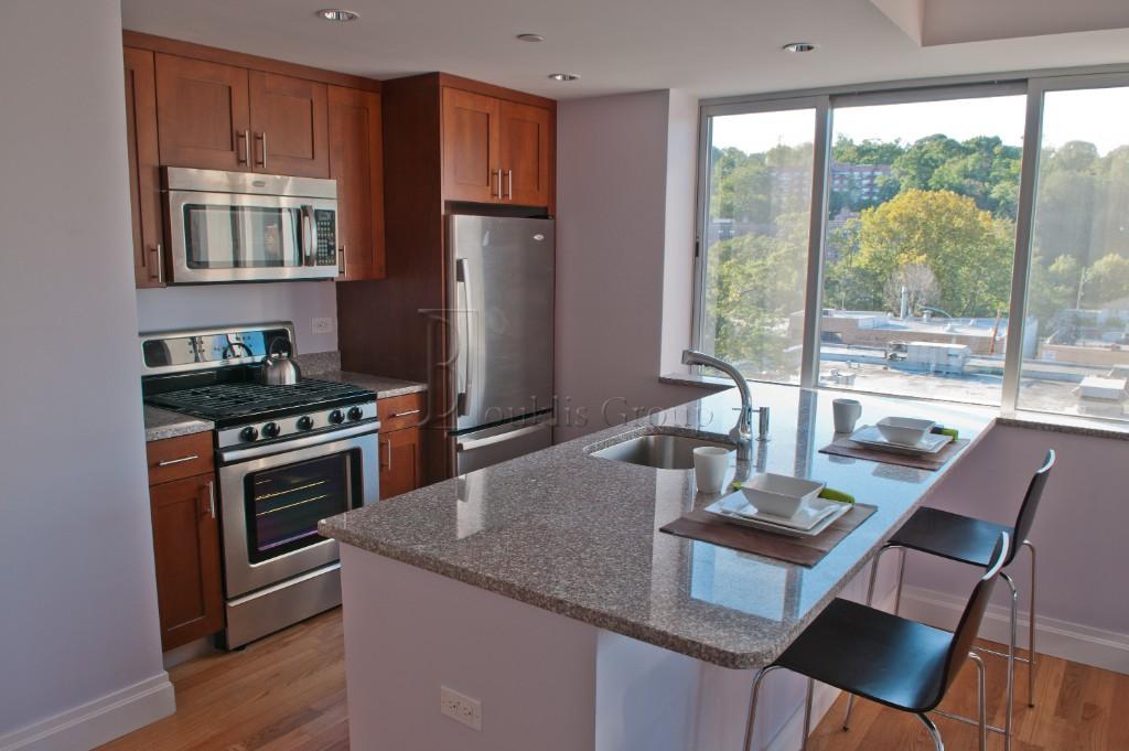 a kitchen with a table chairs and wooden floor