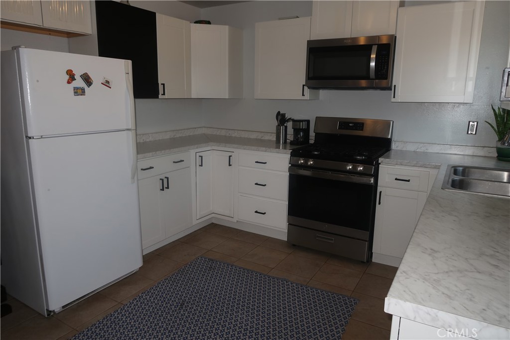 a kitchen with a refrigerator stove and microwave