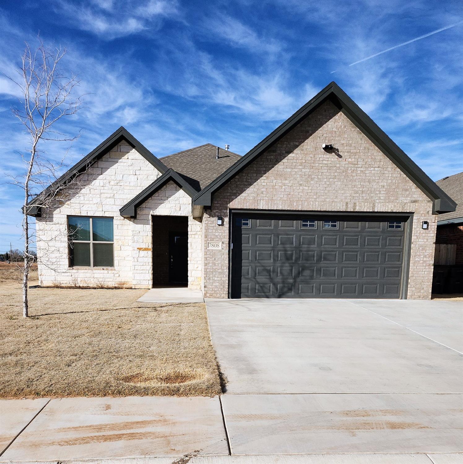 a front view of a house with garage