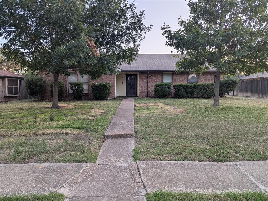 a front view of house with yard and trees