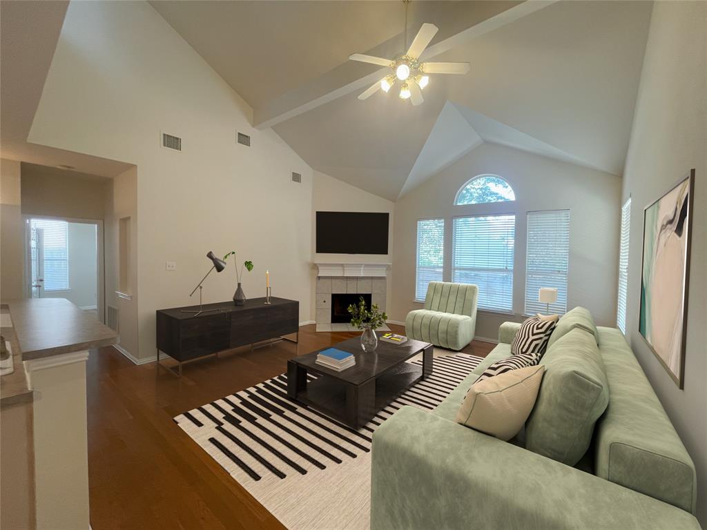 a living room with furniture a fireplace and a flat screen tv