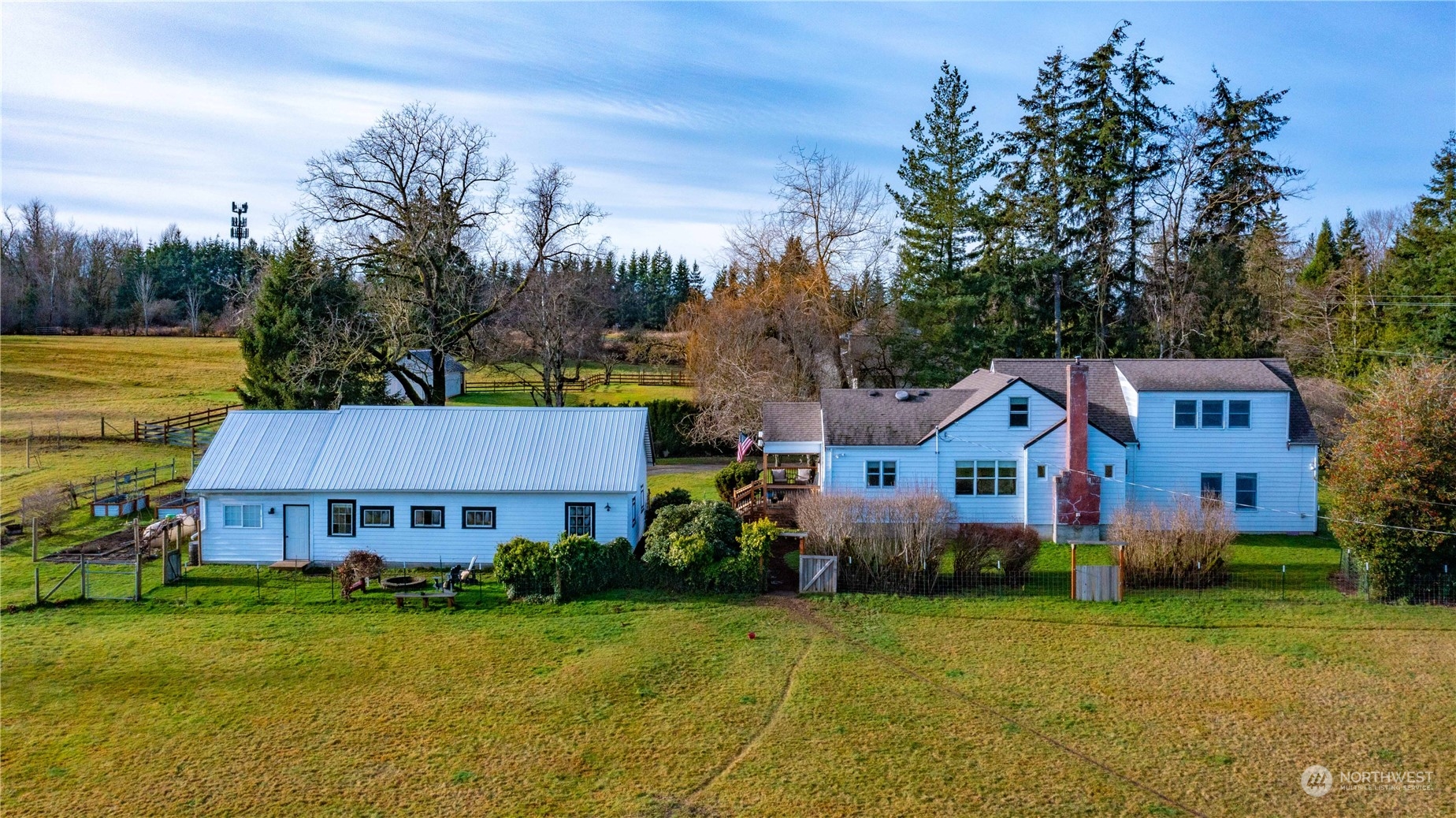 a front view of house with yard and trees in background