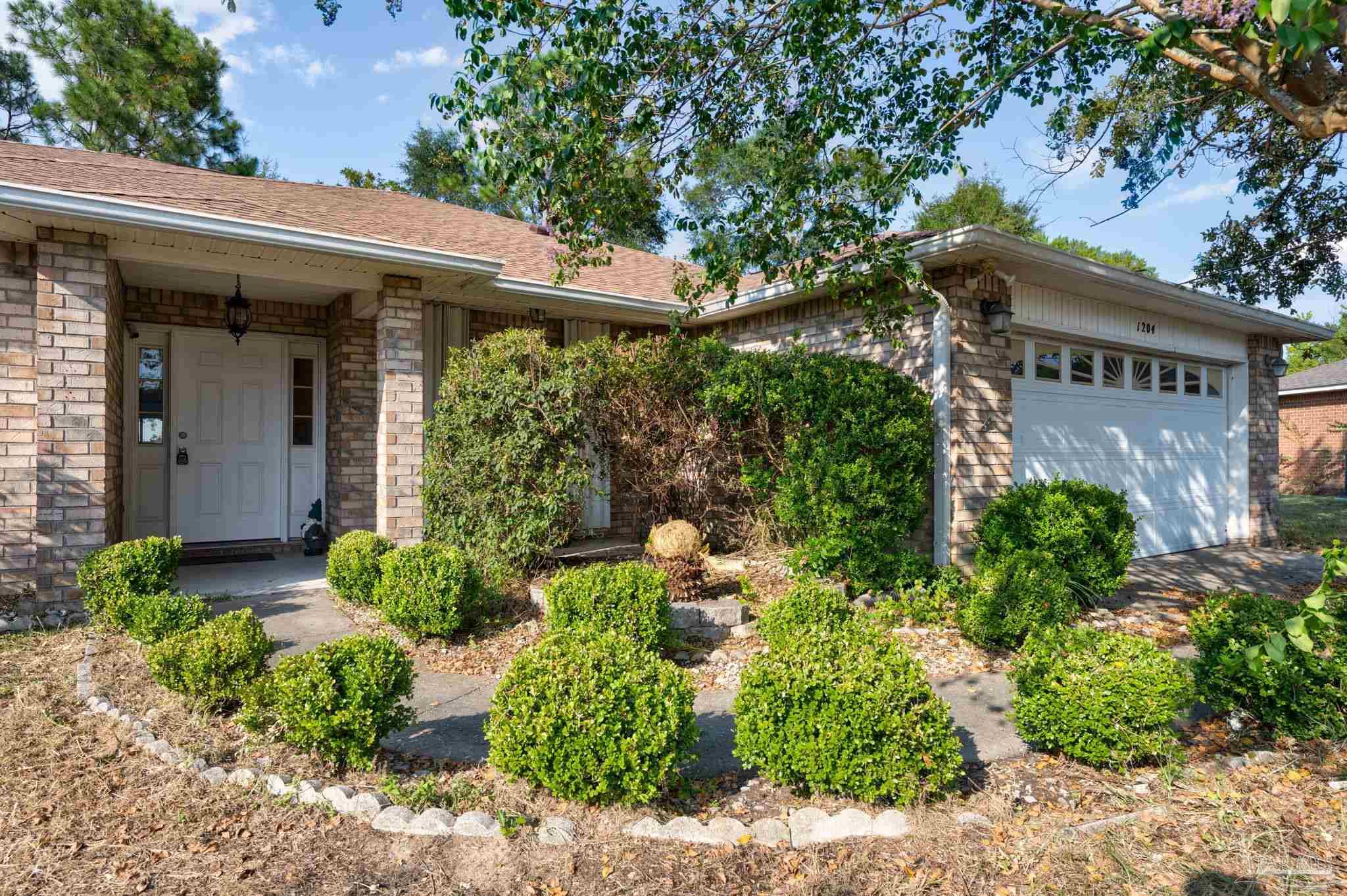 front view of a house with a garden