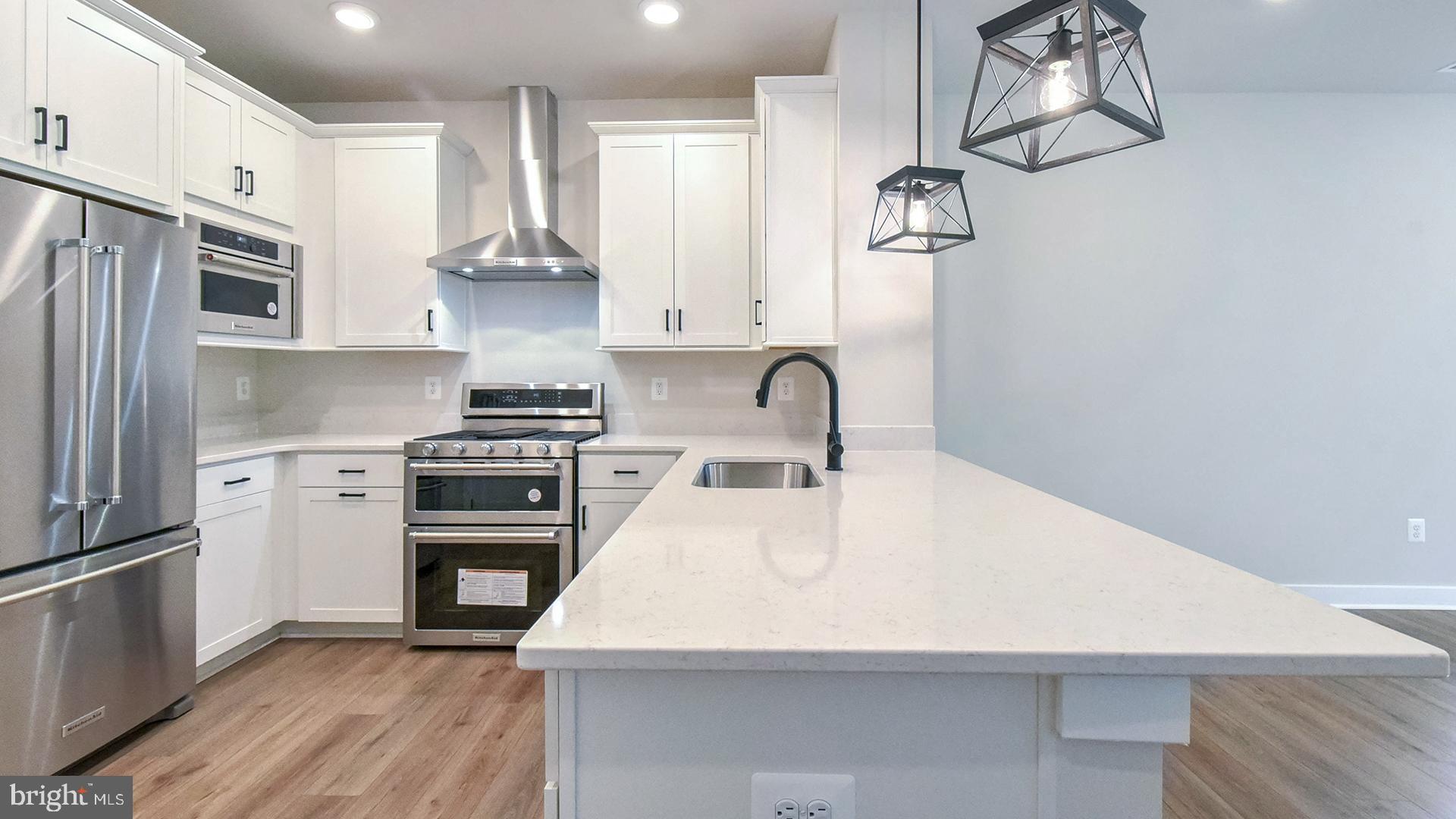 a kitchen with stainless steel appliances a refrigerator sink and cabinets