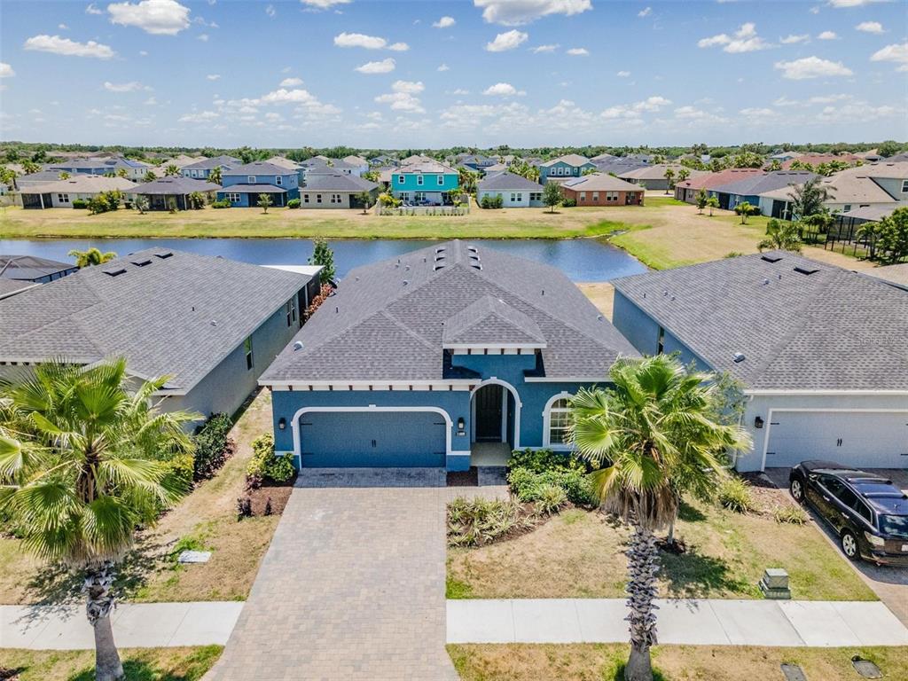 an aerial view of a house with a lake view