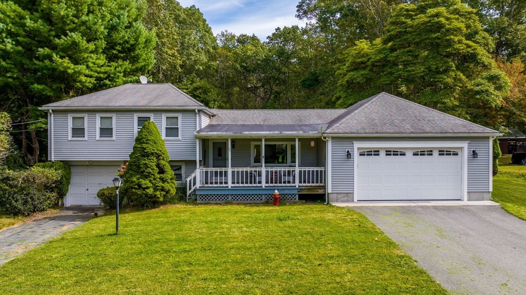 a front view of a house with a garden