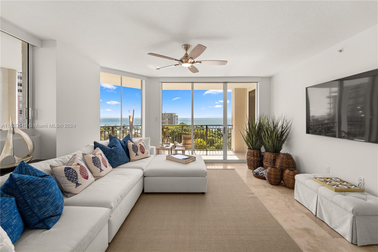 a living room with furniture ceiling fan and a window