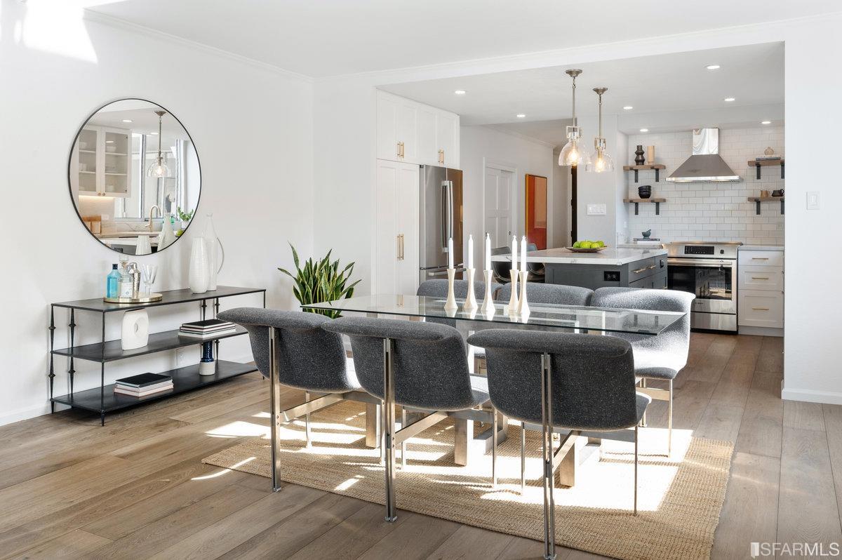 a living room with furniture a mirror and a chandelier