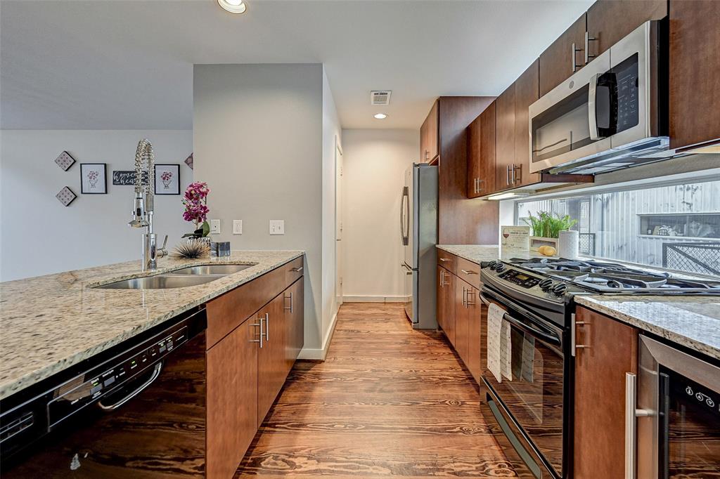 a kitchen with stainless steel appliances granite countertop a stove and a sink