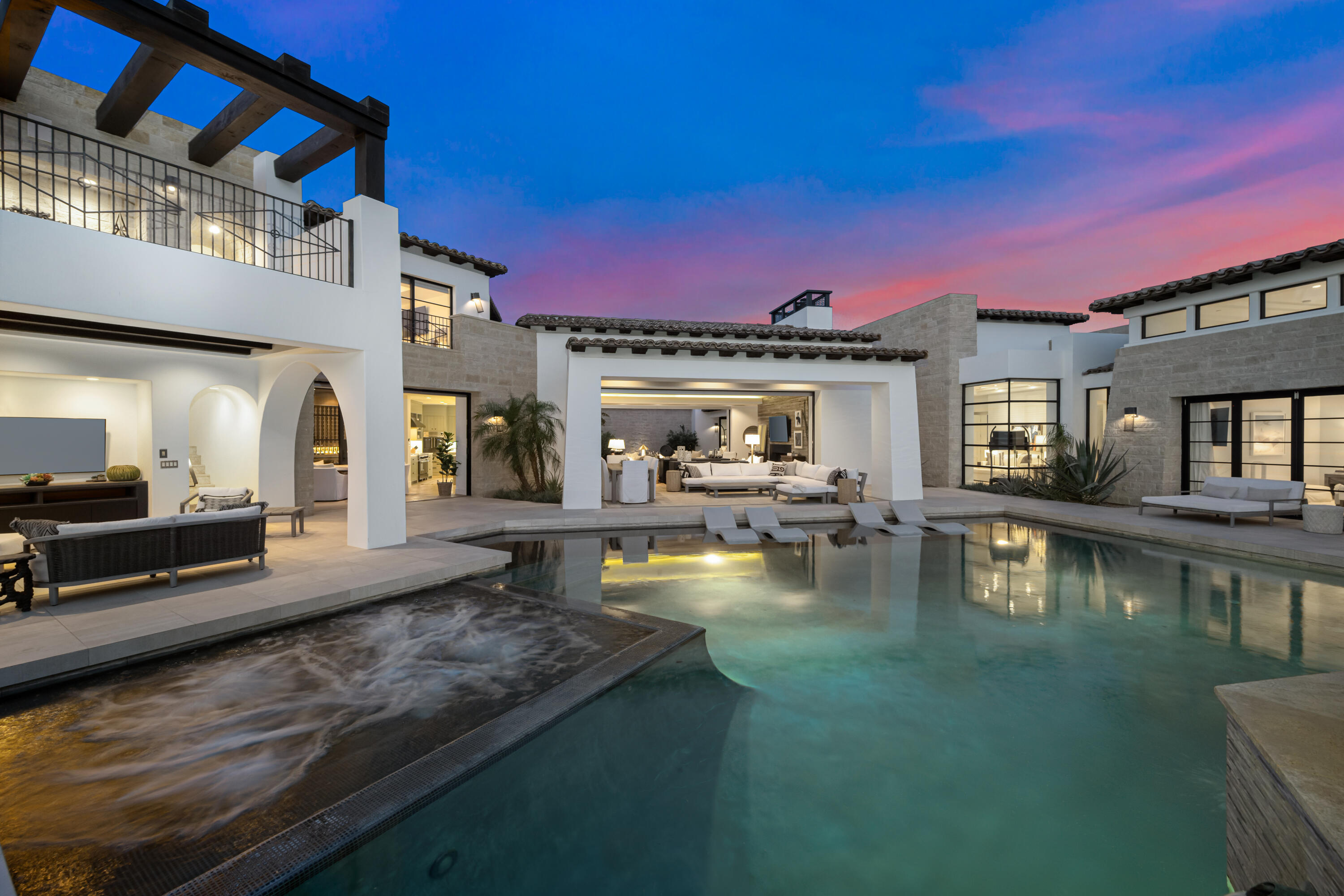 a view of a swimming pool with outdoor seating