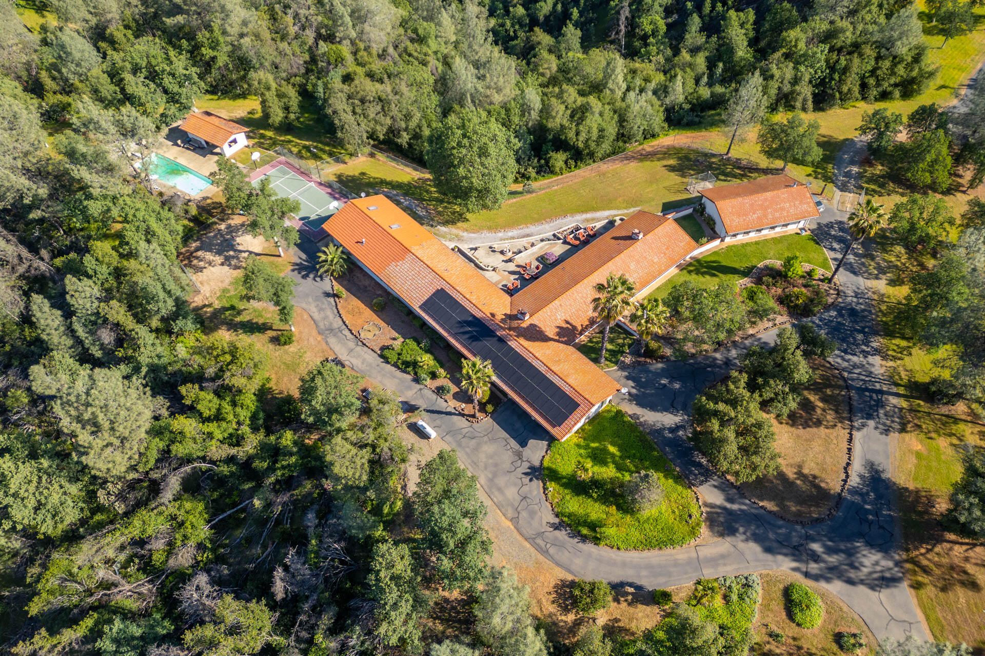 an aerial view of a house with a yard and garden