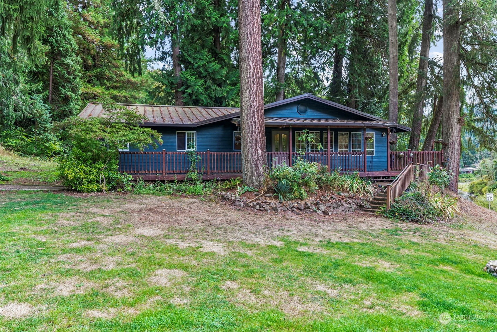 a view of a wooden house with a yard