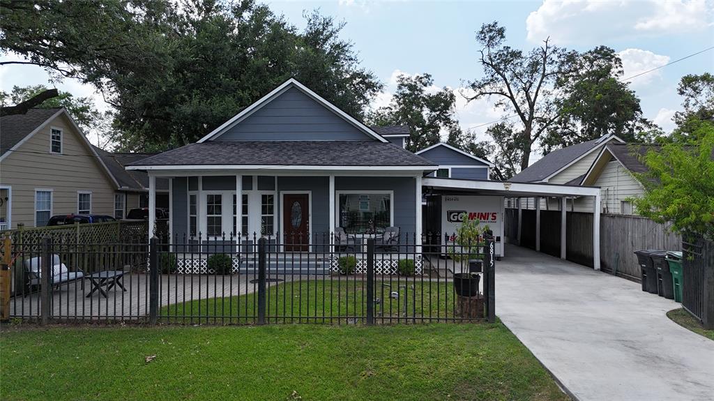 a front view of a house with a garden and yard