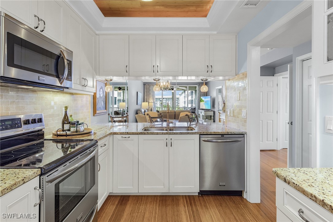 a kitchen with stainless steel appliances granite countertop a sink and stove top oven