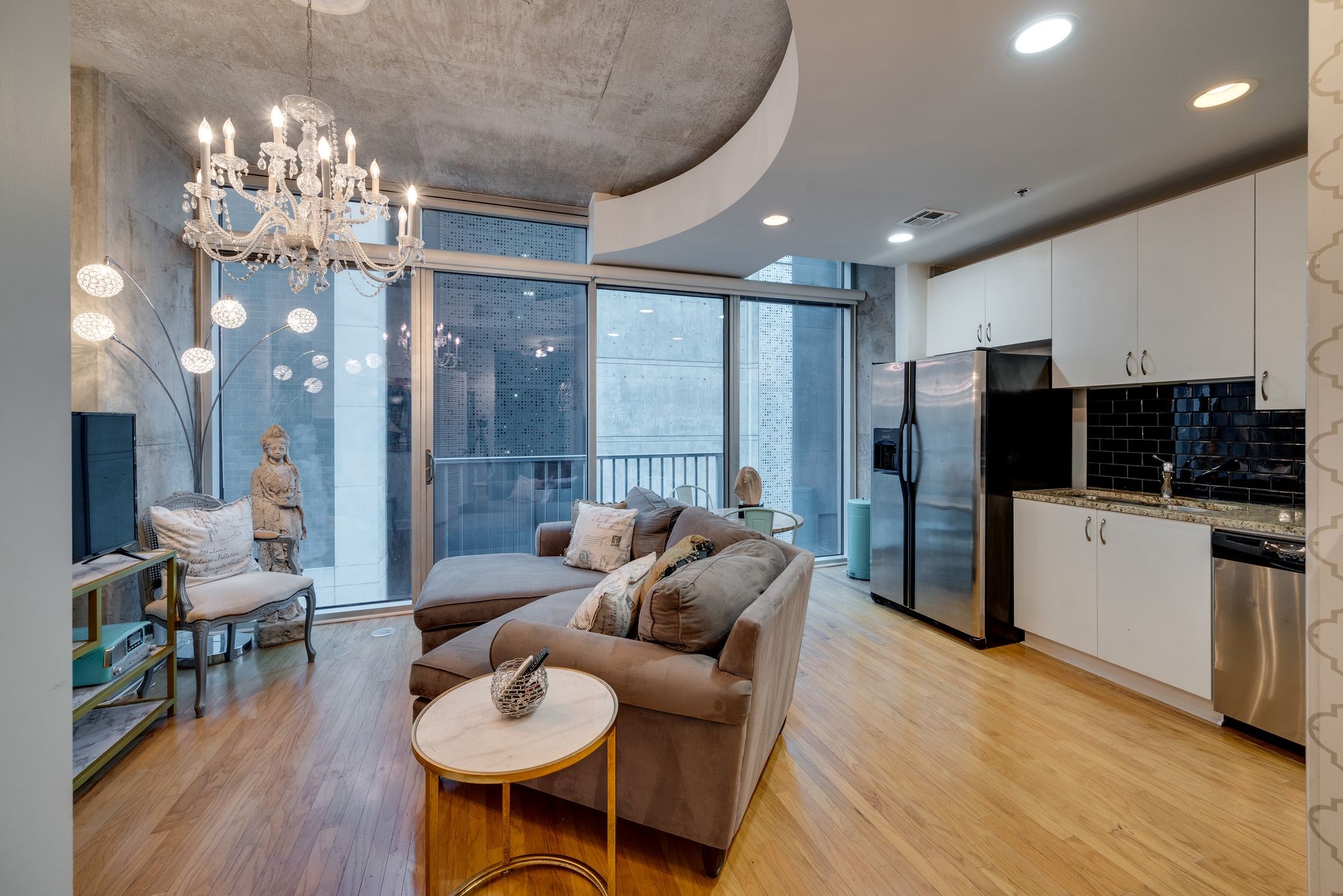 a living room with furniture and a chandelier