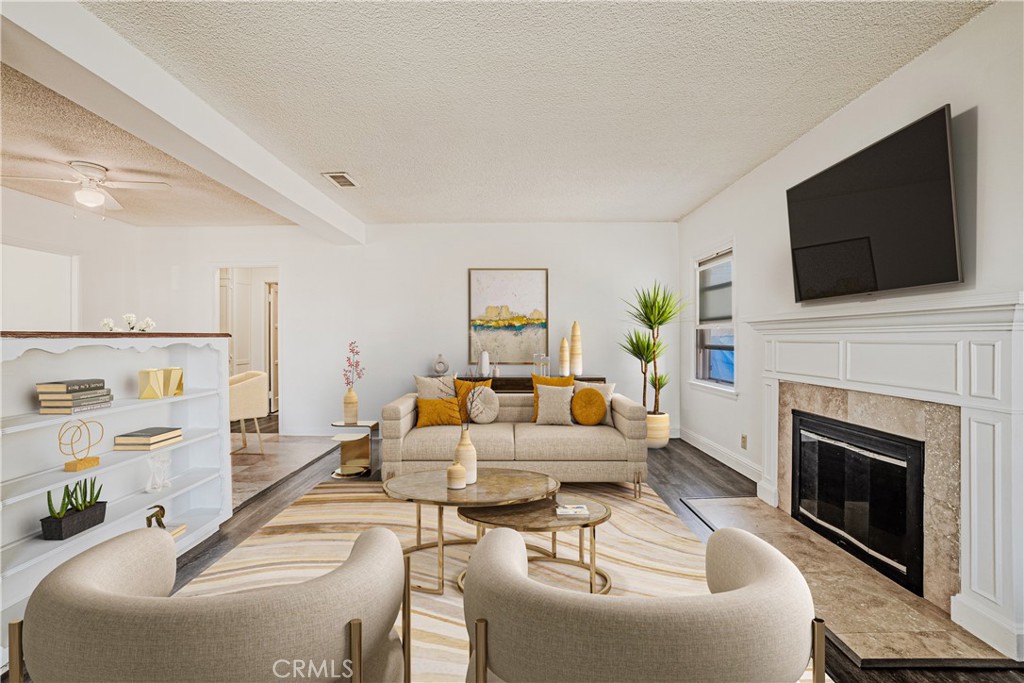 a living room with furniture fireplace and flat screen tv