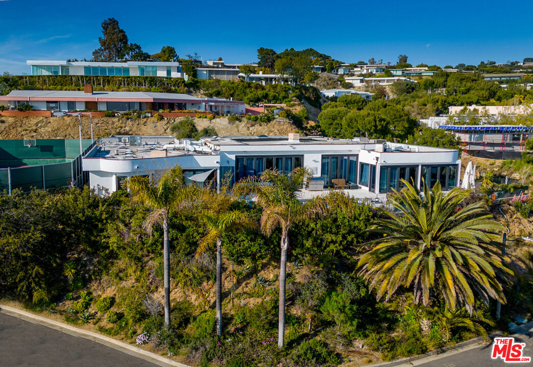 an aerial view of residential houses with outdoor space and river