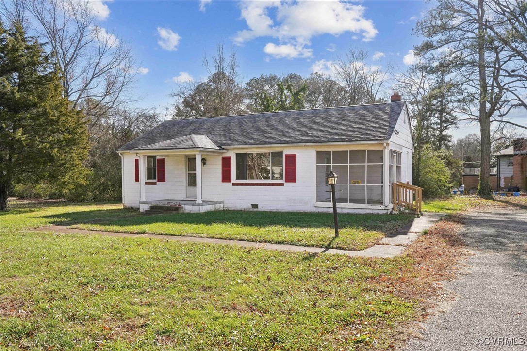 a view of a house with a yard and tree s