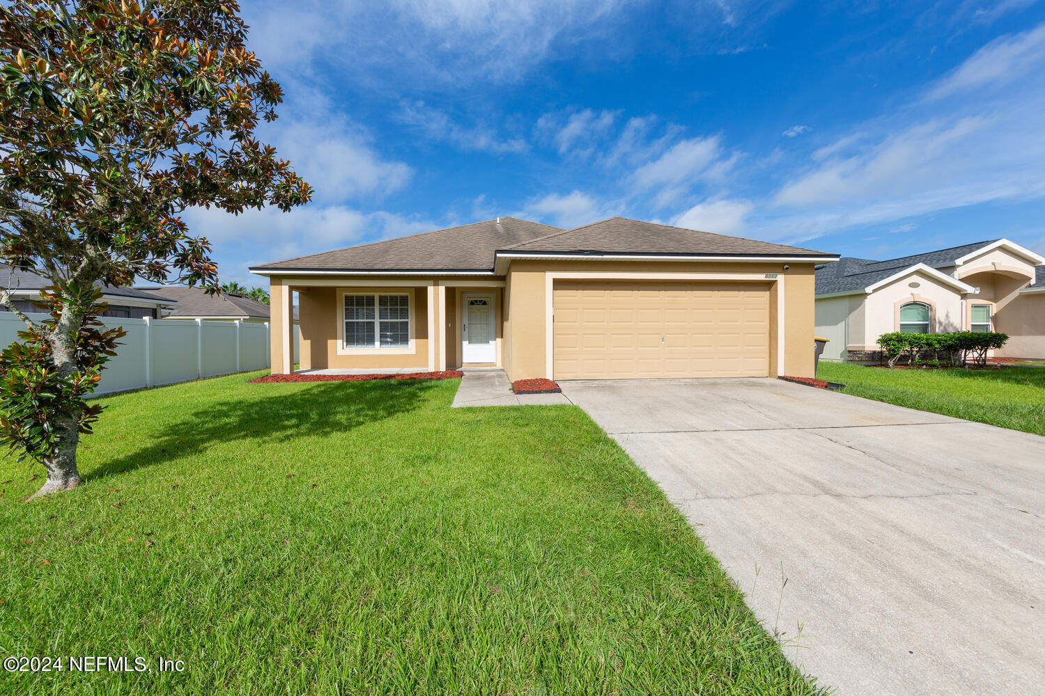 a front view of house with yard and green space