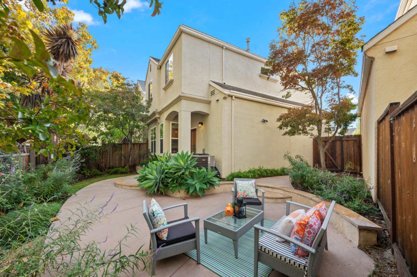 a view of backyard with outdoor seating and plants