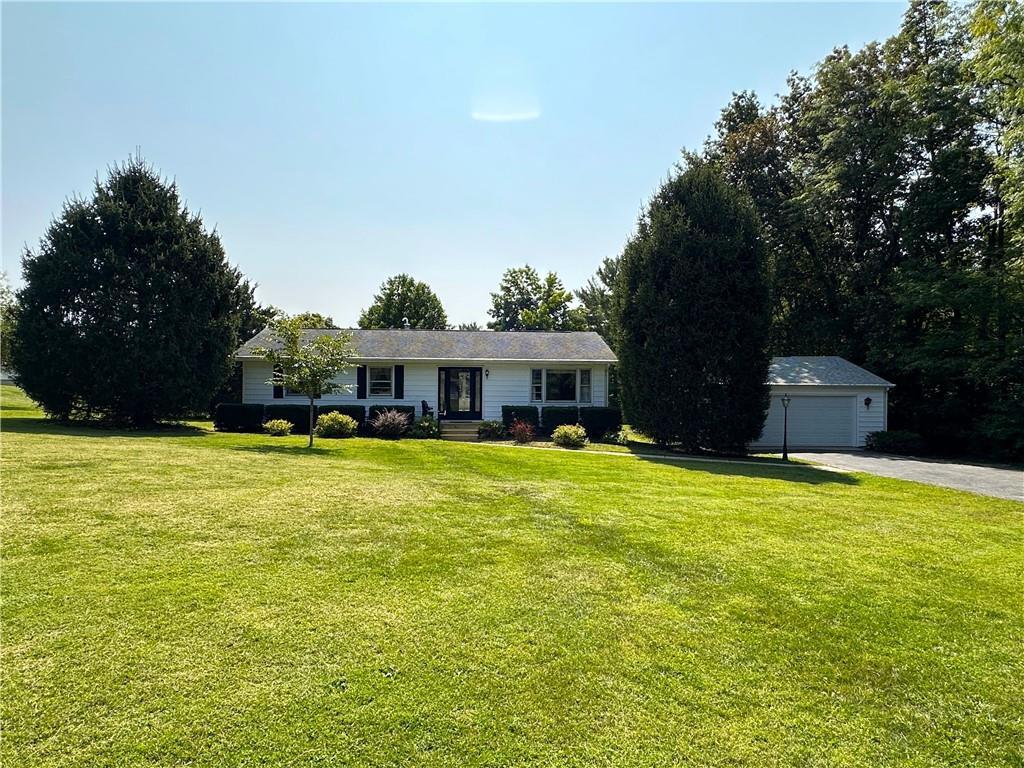 a front view of house with yard and swimming pool