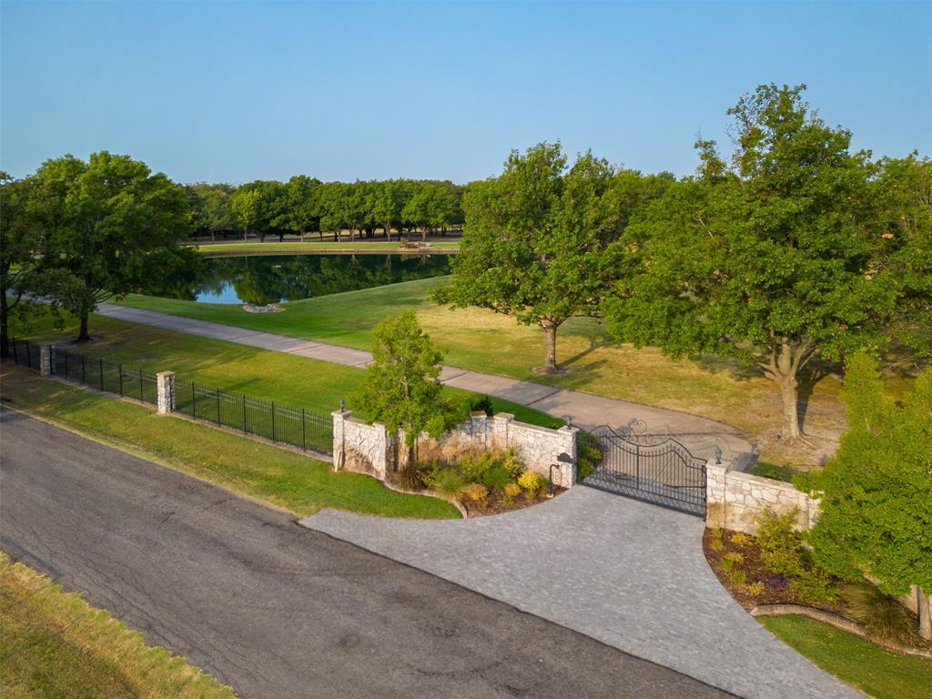 an aerial view of a house with a yard and lake view