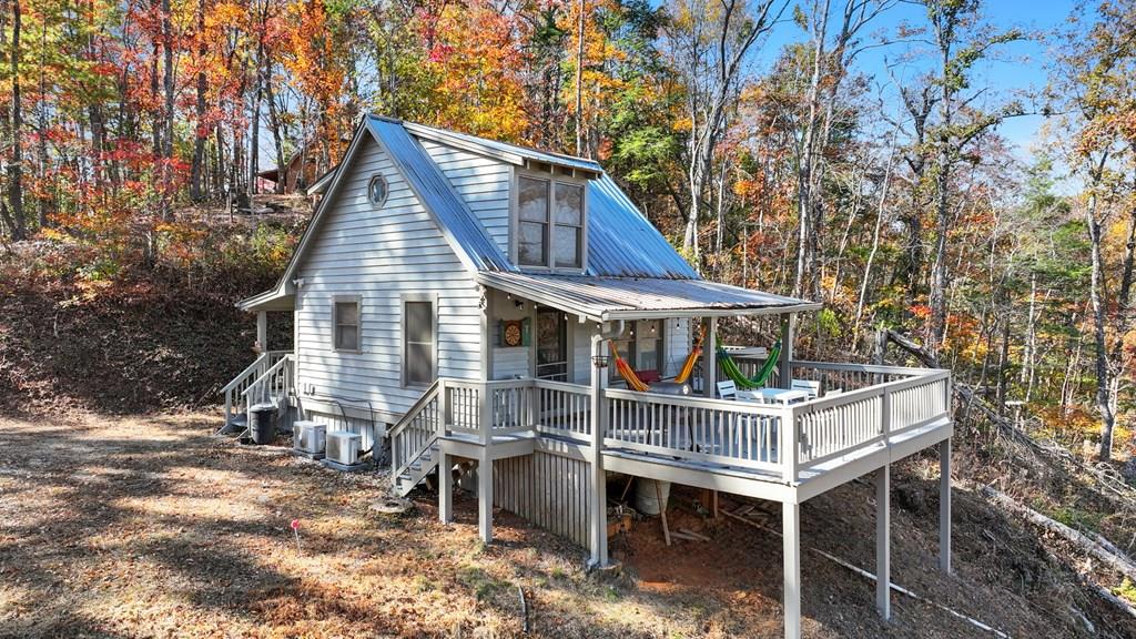 a view of house with a yard and seating space