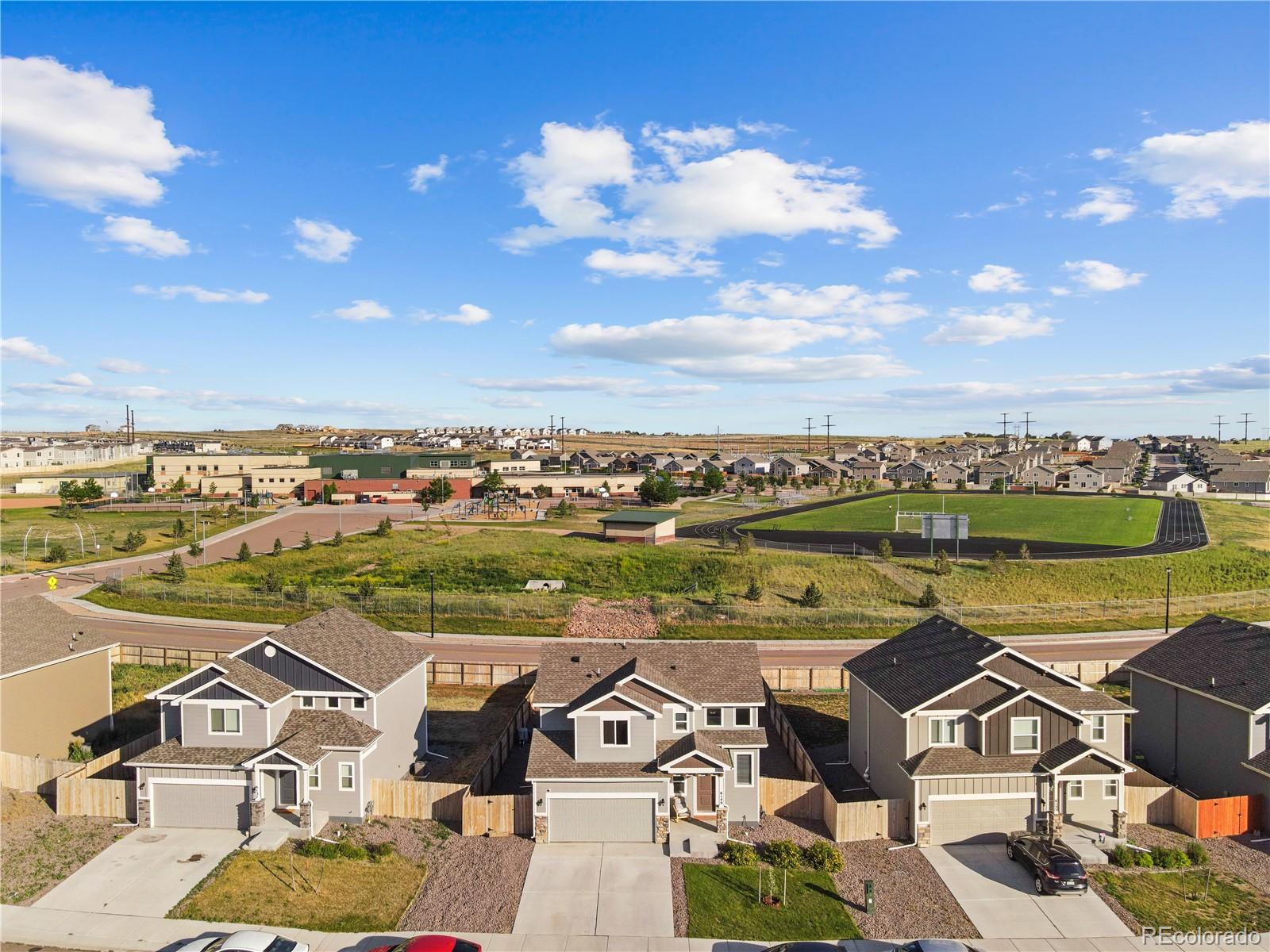 an aerial view of a residential houses with outdoor space and ocean view