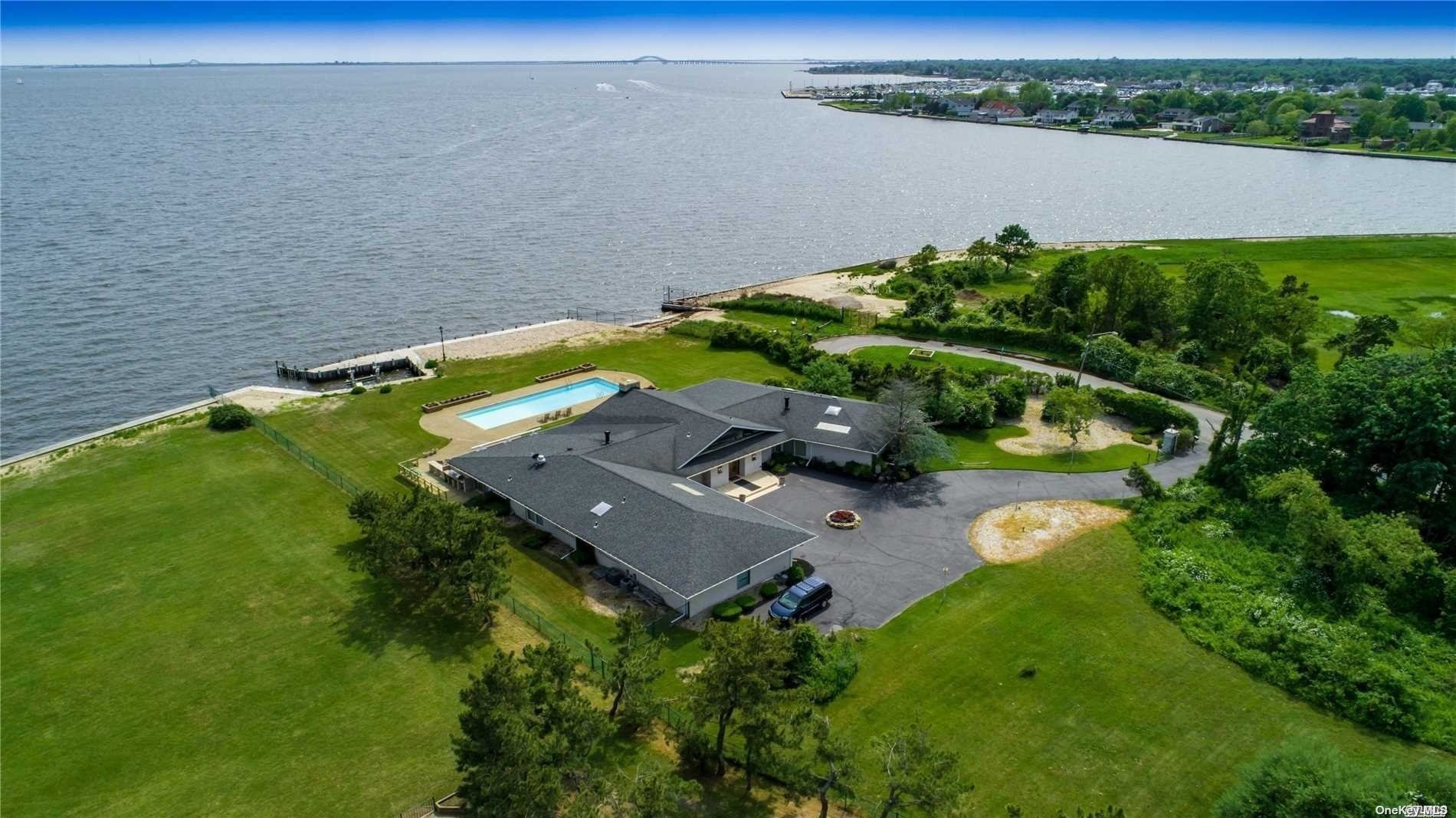 an aerial view of a house with a lake view