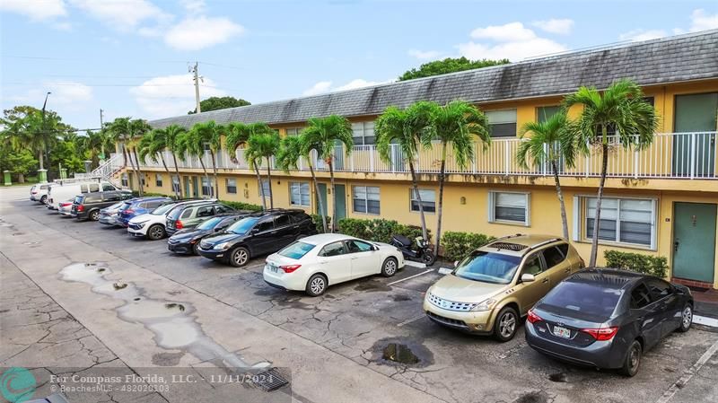 a couple of cars parked in front of a house