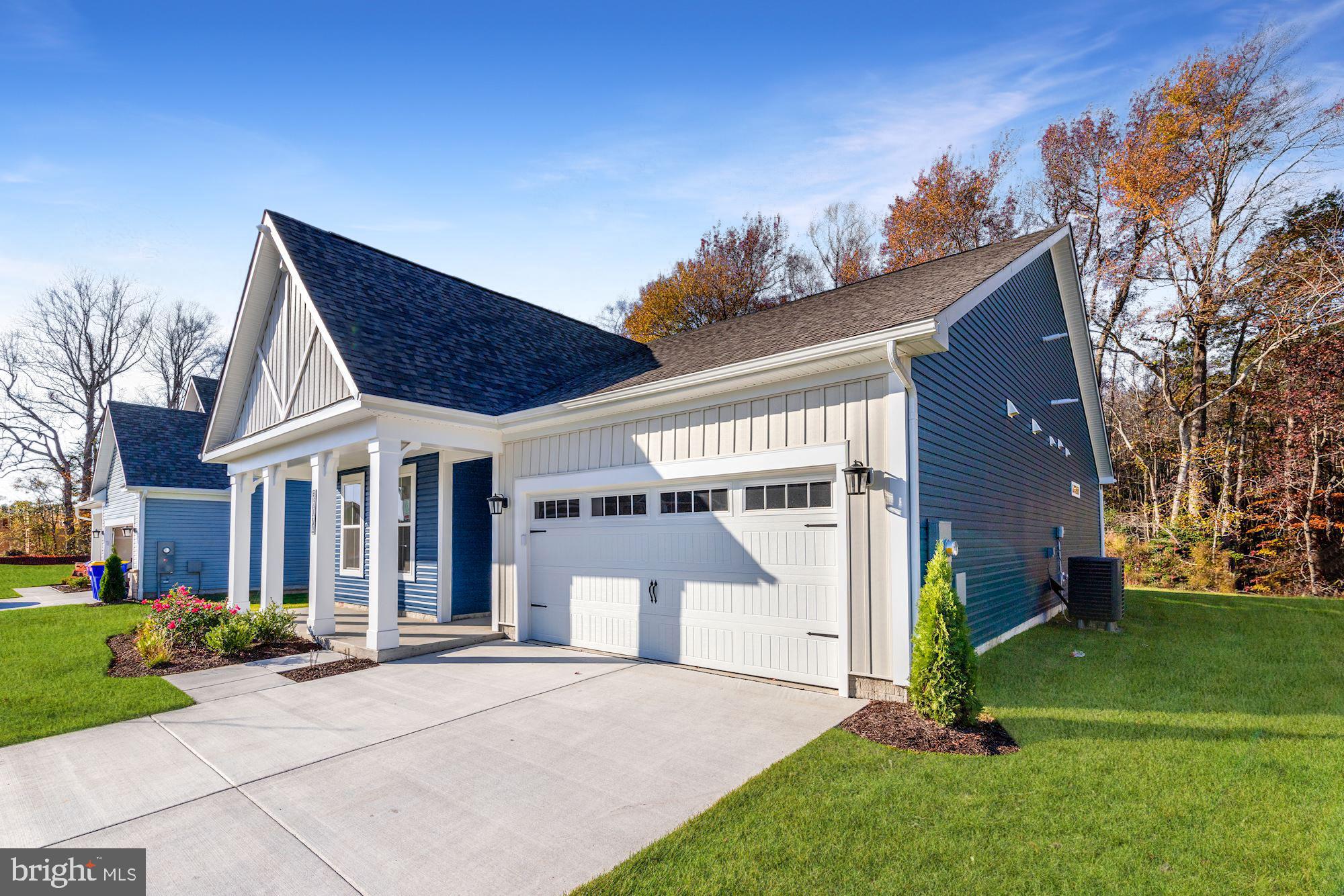 a front view of a house with a garden and yard