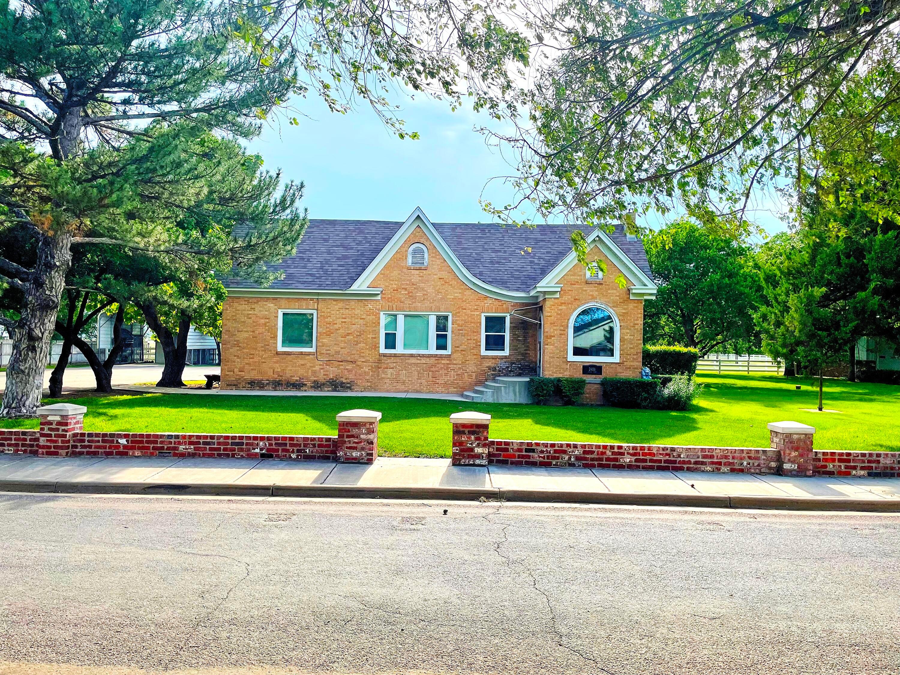 a front view of house with yard and green space