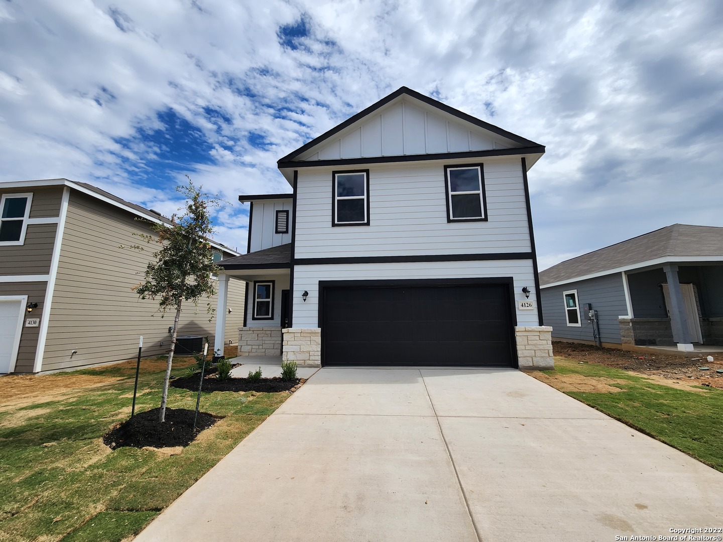 a front view of a house with a yard