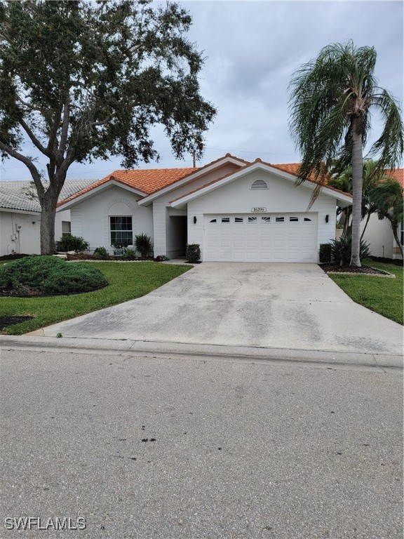 a view of white house with a yard and palm trees