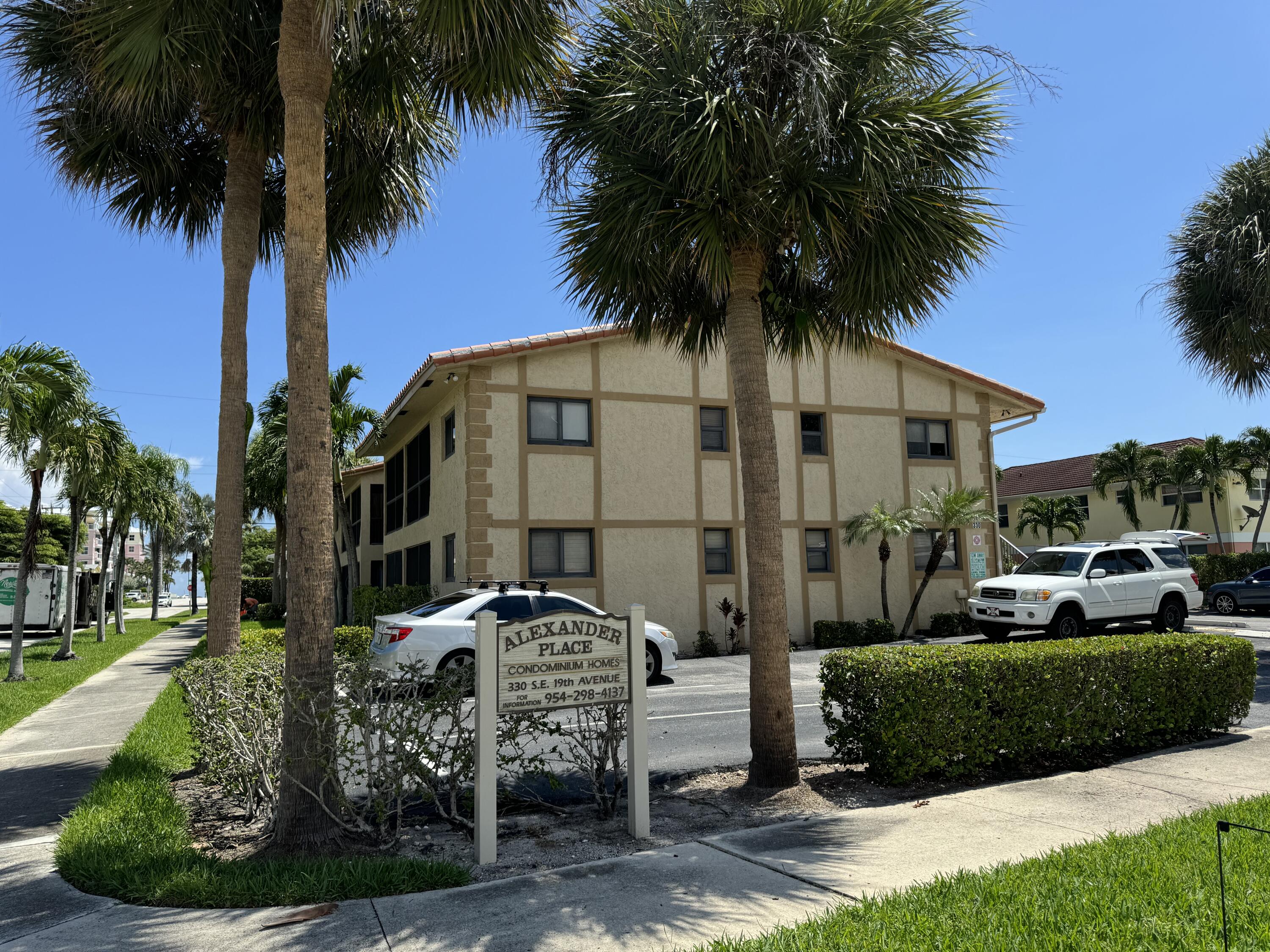 a front view of multiple houses with yard