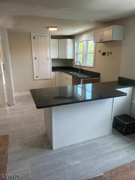 a kitchen with granite countertop a stove a sink and a granite counter tops