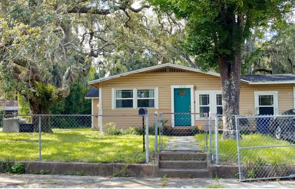 a view of house with a yard