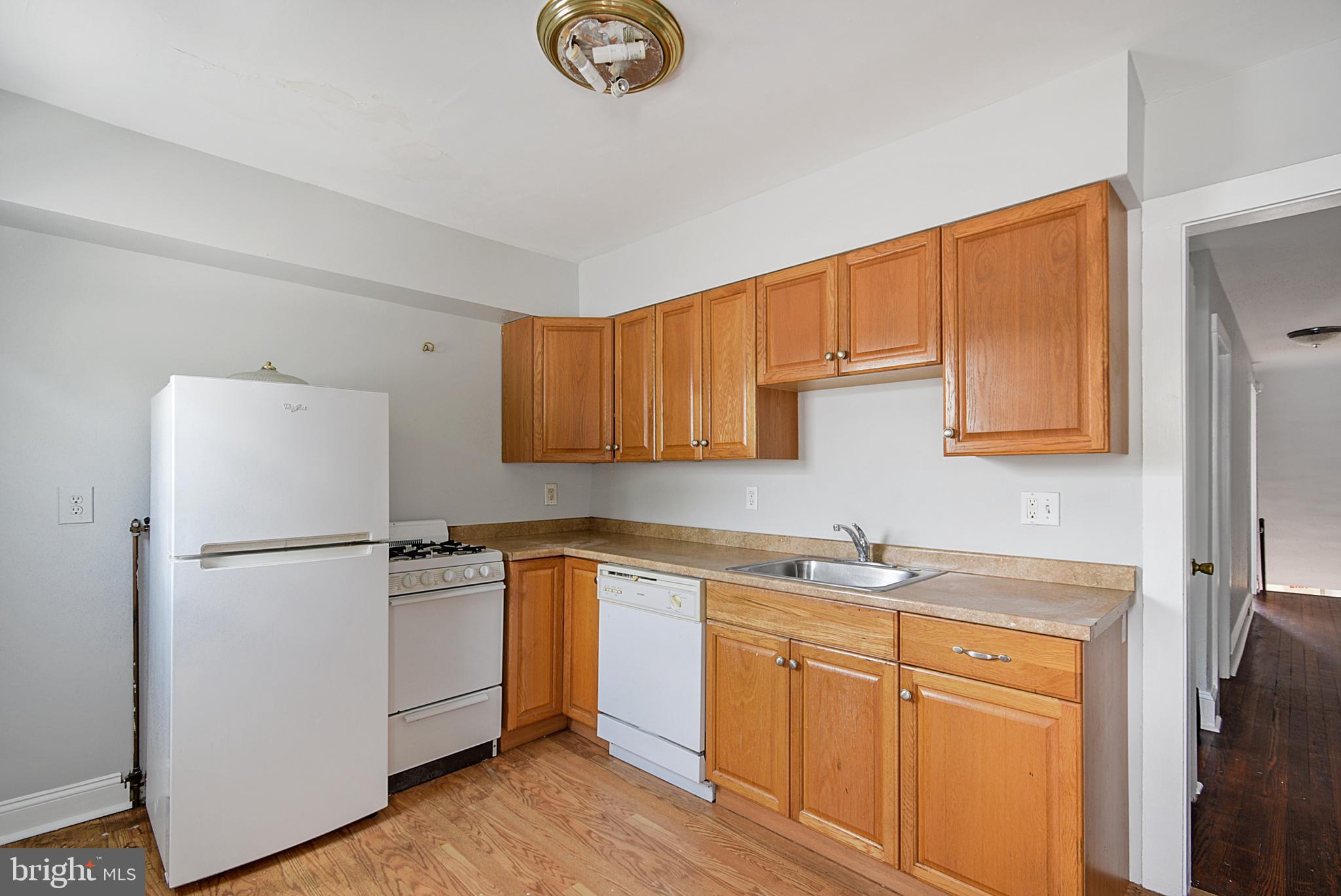 a kitchen with stainless steel appliances granite countertop a refrigerator sink and cabinets