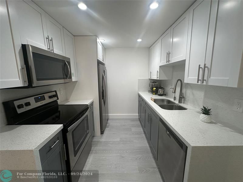 a kitchen with a sink a stove and refrigerator