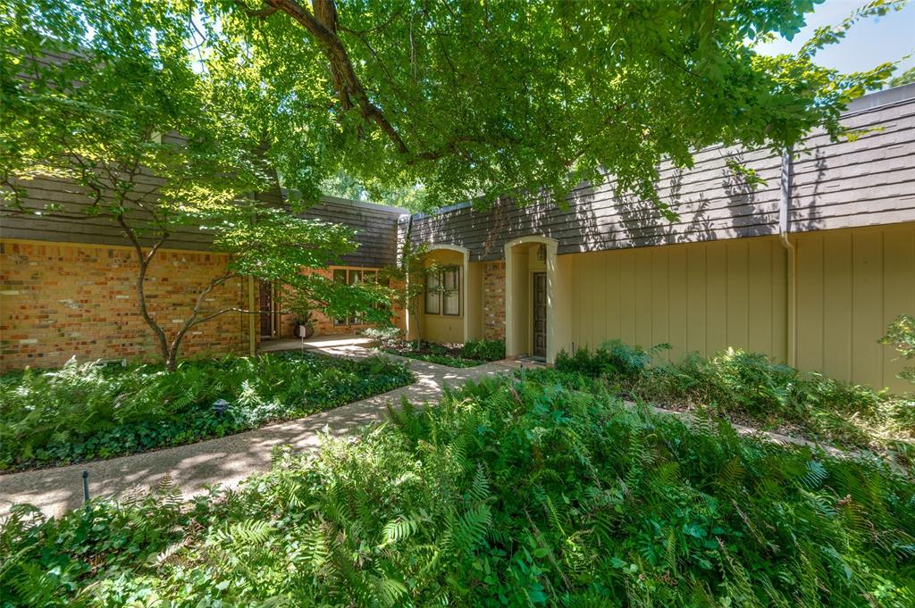 a backyard of a house with lots of green space and lake view