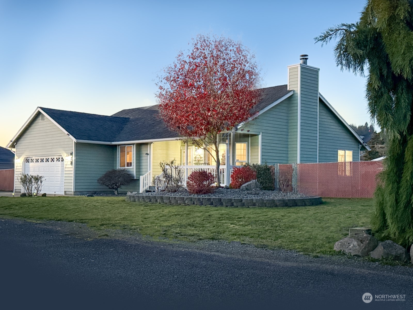 a view of a house with a big yard and potted plants