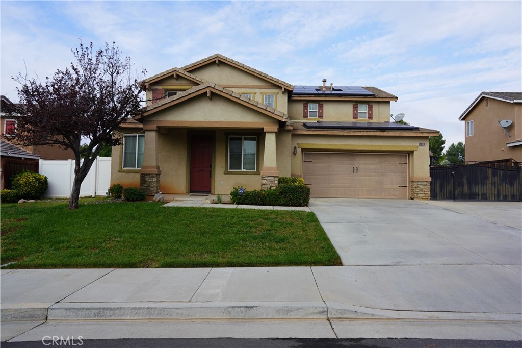 a front view of a house with a yard and garage