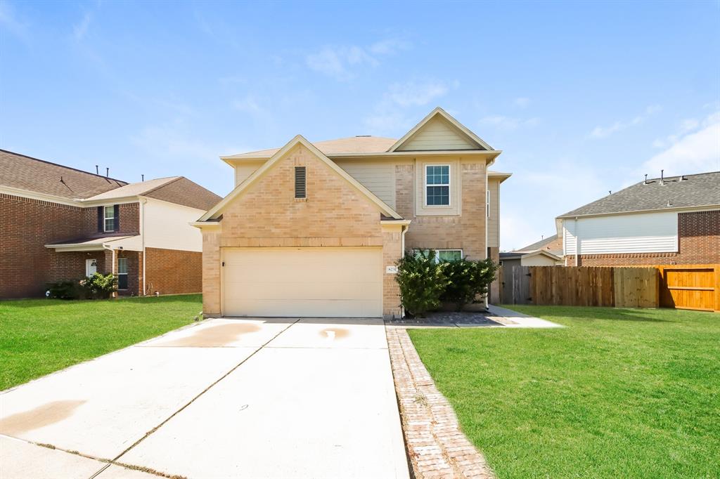 a view of a house with a yard and pathway