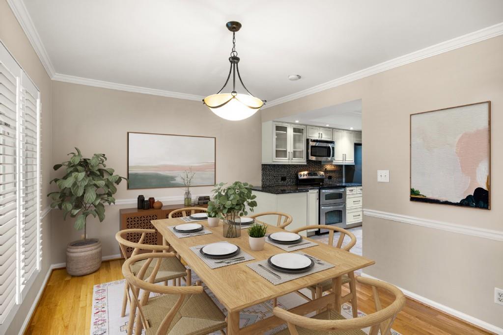 a view of a dining room with furniture a chandelier and wooden floor