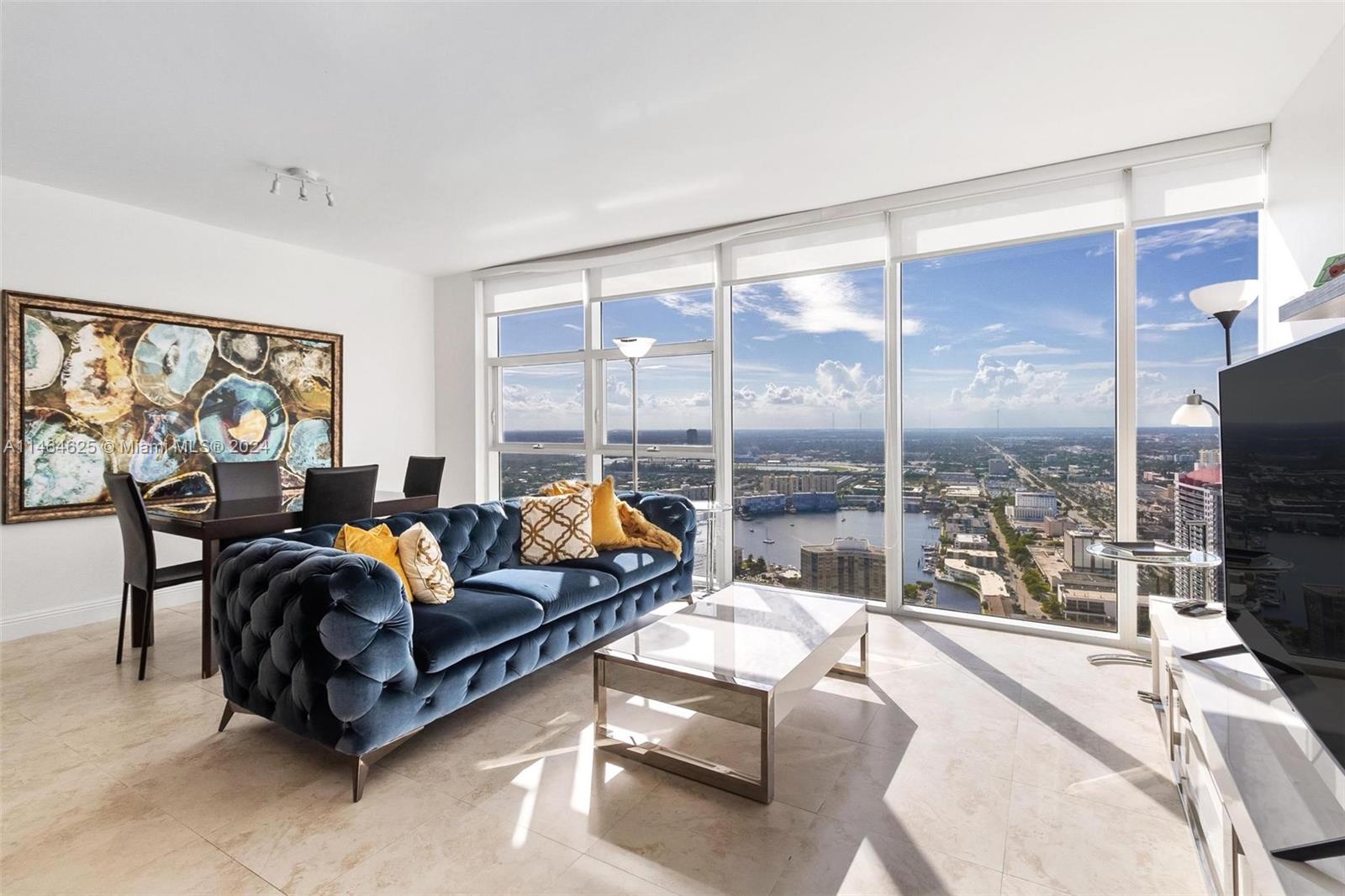 a living room with furniture large windows and a flat screen tv