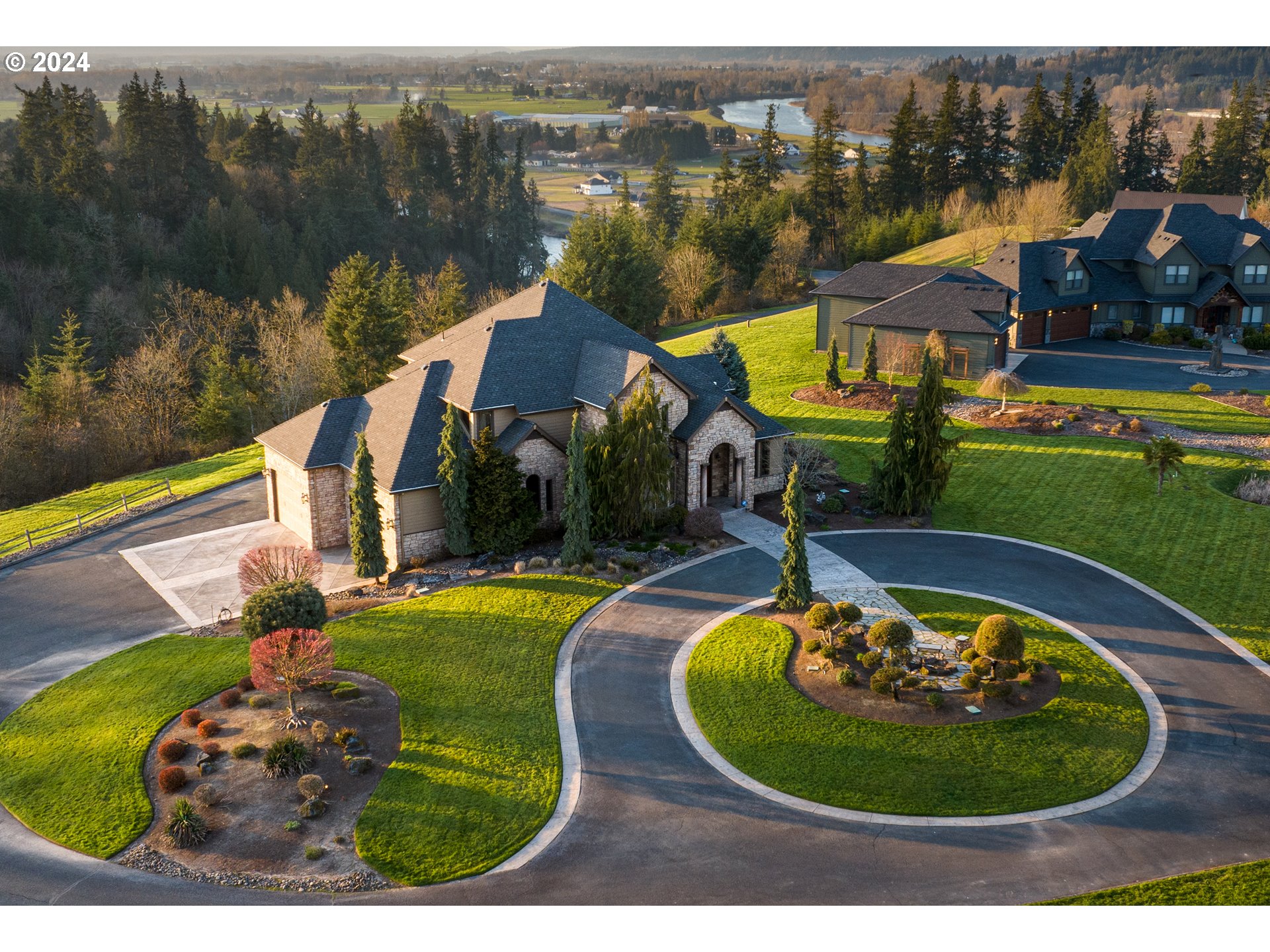 an aerial view of a house with garden space lake view and mountain view in back