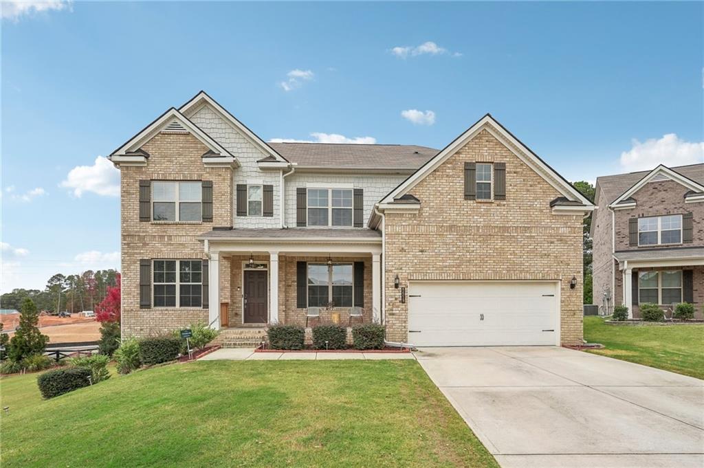 a front view of a house with a yard and garage